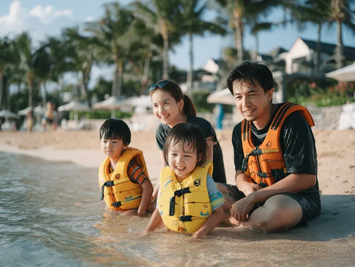 Toddler-friendly beach in Bali 2026 – A young child playing safely in the shallow, calm lagoon waters of Sanur while a parent supervises nearby.