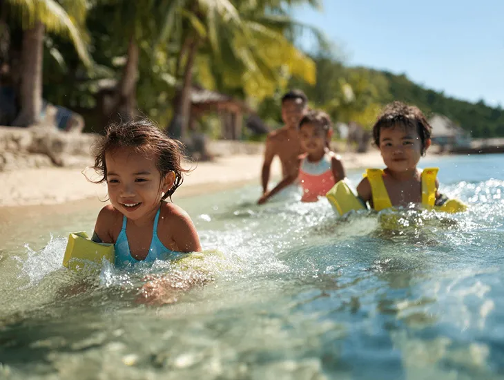 Kid-Friendly Beach in Nusa Lembongan 2026 – A parent guiding a toddler in the shallow, clear water of Mushroom Bay.