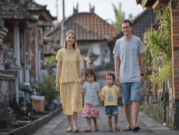 Balinese Architecture 2026 – A traditional compound entrance featuring a stone angkul-angkul gate and a layered bamboo mat roof.