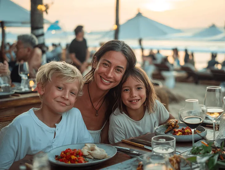 family hotels in Uluwatu, Bali 2026 – A professional caregiver supervising children near a secure resort playground with ocean views.