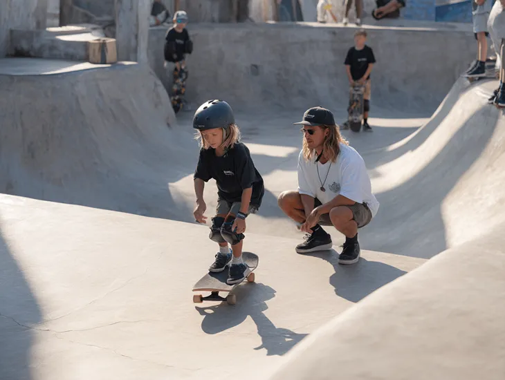 Family Hotels in Keramas, Bali 2026 – A child playing on a mini-skate ramp with professional safety gear including a helmet and knee pads.
