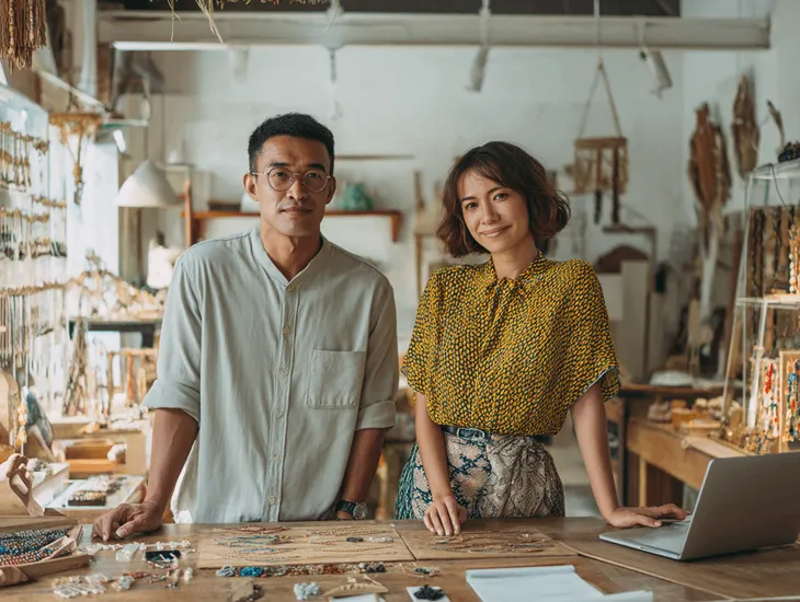 Babysitter in Bali 2026 – A caregiver helping a child walk on the sustainable workshop paths.