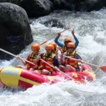 Ayung River Rafting in Bali 2026 – A professional babysitter ensures a young child’s life jacket is fitted correctly before boarding a raft.