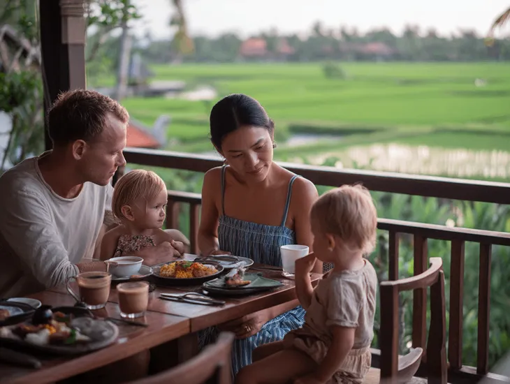 Childcare Supplies 2026 – A caregiver organizing a "cafe kit" with coloring books and small puzzles on a dining table.