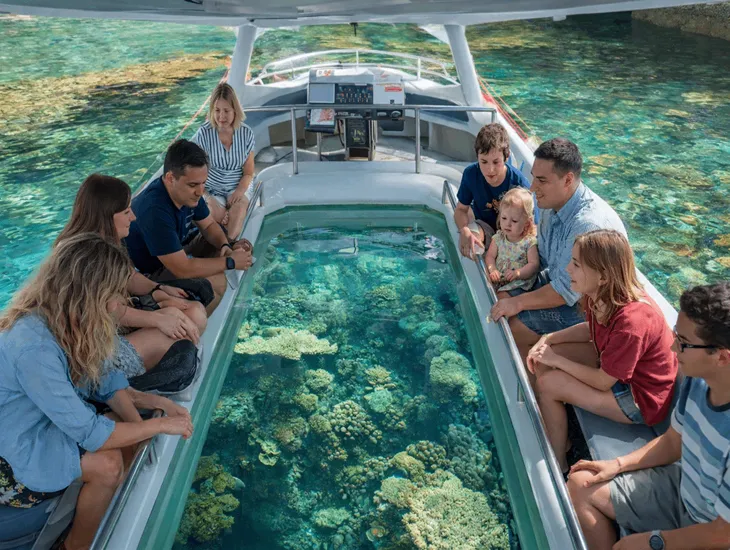 Travel Childcare in Bali 2026 – Professional travel assistants supervising children securely on the shaded tropical beach.