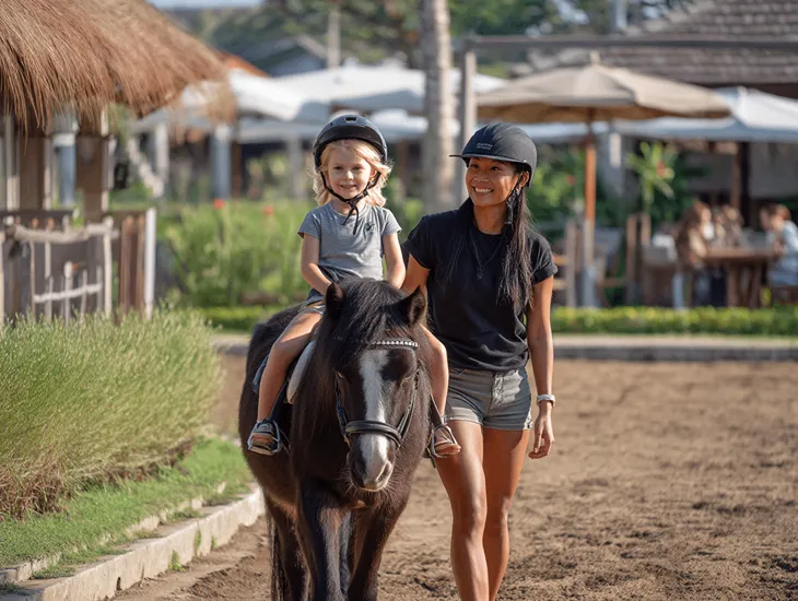 Horse Riding in Indonesia 2026 – Professional stable staff leading a young child on a pony around a secure track