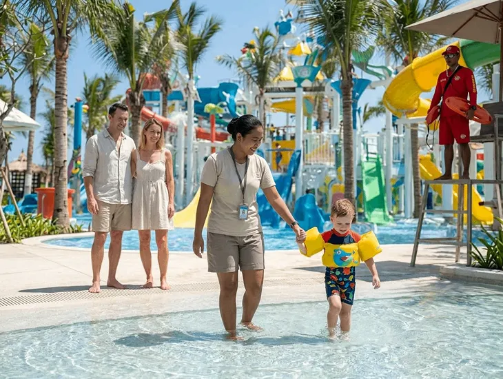 Lifeguard supervision 2026 – Families floating down the Lazy River in large inflatable tubes.
