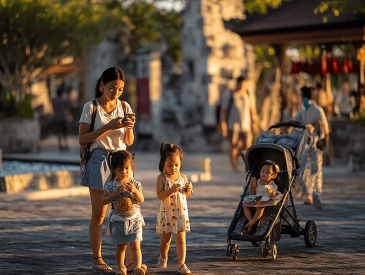 Traditional Dance in Indonesia 2026 – Caregiver helping children find seats before a performance.