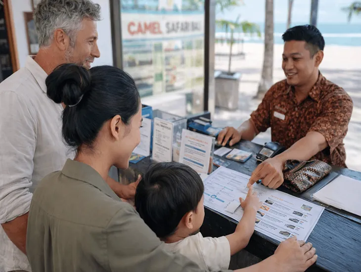 Animal activities in Indonesia 2026 – A professional sitter in Bali helping children at a safari ticket booth.