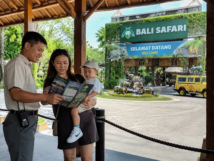 Bali Safari & Marine Park 2026 – Childcare provider checking show times at the park entrance