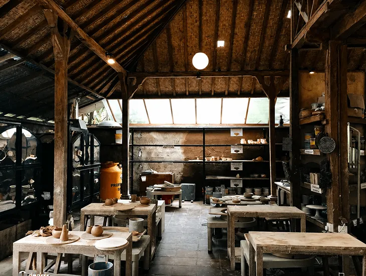 Ubud ceramic studio 2026 – Professional babysitter helping student with pottery wheel safety