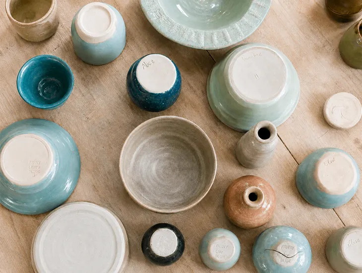 Ceramic arts in Indonesia 2026 – Babysitter guiding children in safe studio cleaning practices