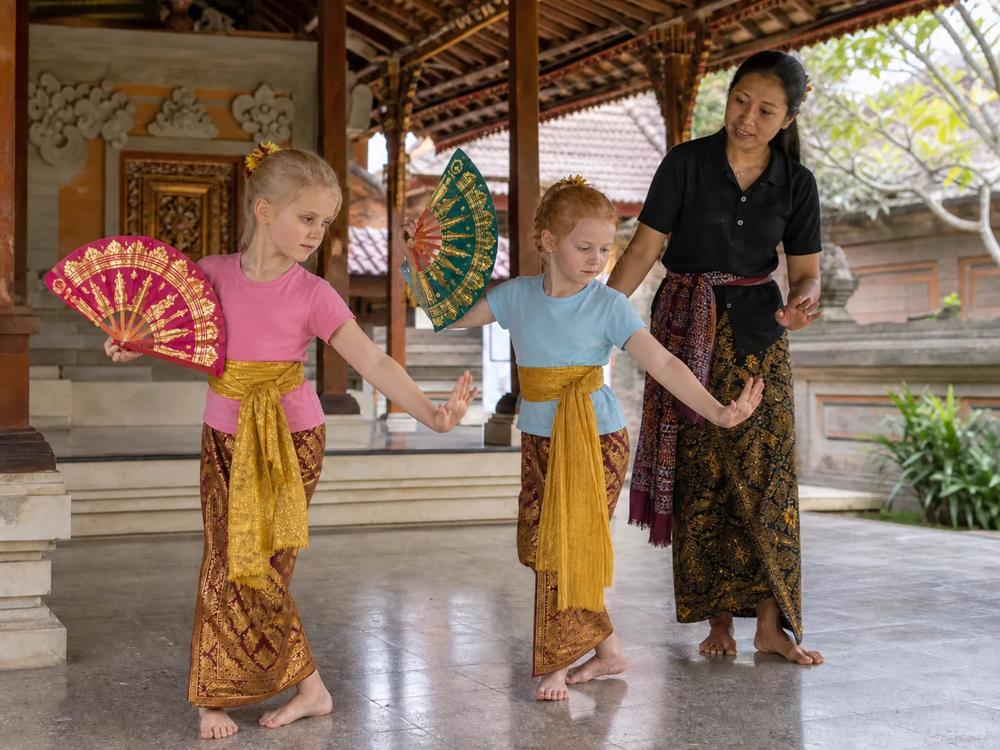 Cultural Activities in Bali 2026 – Babysitter guiding children through basic posture and hand gestures