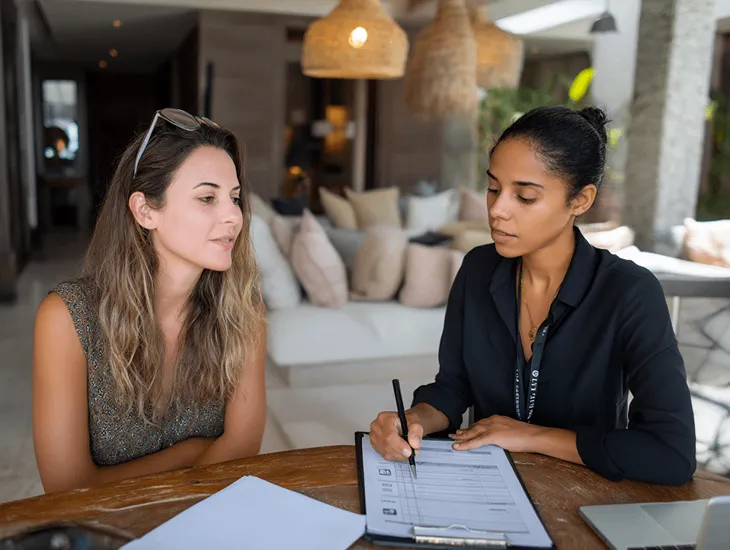 Trusted Babysitter Agency in Bali 2026 – Parent carefully reviewing domestic caregiver documents