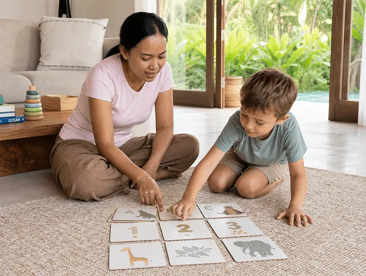 Nanny in Bali 2026 – Professional caregiver assisting a child with educational play in a villa.