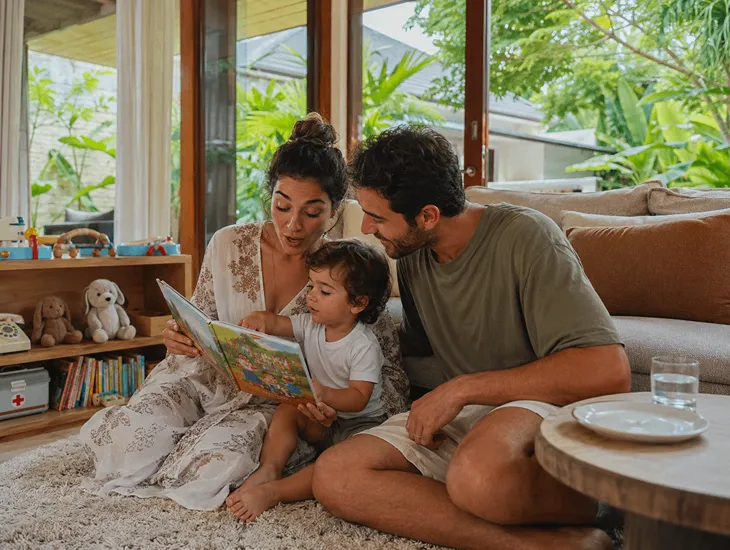 The 6Cs of Education 2026 – Babysitter in Indonesia reading a colorful storybook with a toddler