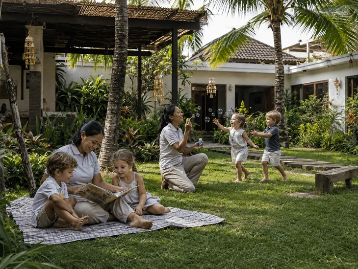 Bali Childcare Team 2026 – Babysitters interacting with children in a shaded villa garden