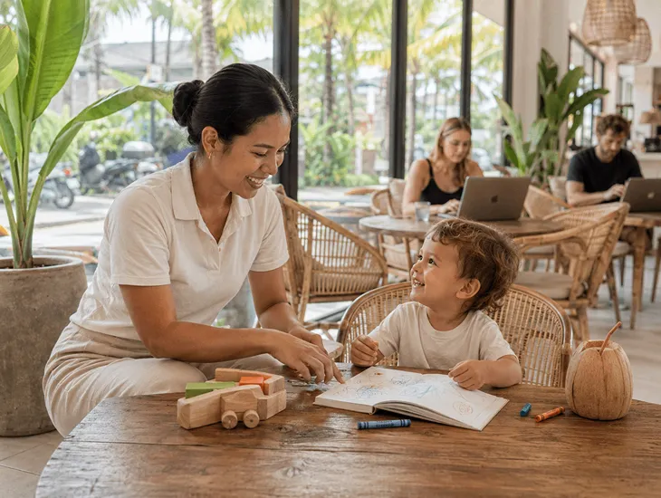 Trusted Babysitters in Bali 2026 – Happy toddler smiling with a professional caregiver in a Canggu cafe